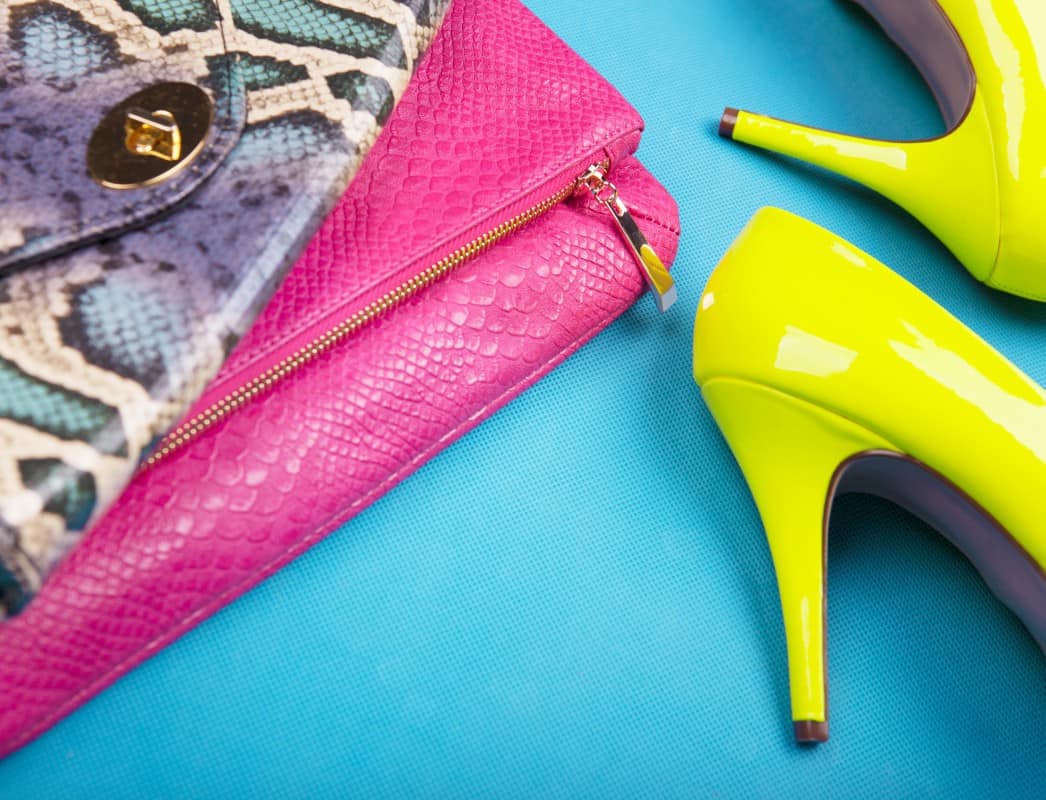 Neon high heels, and snakeskin print bag, woman fashion concept