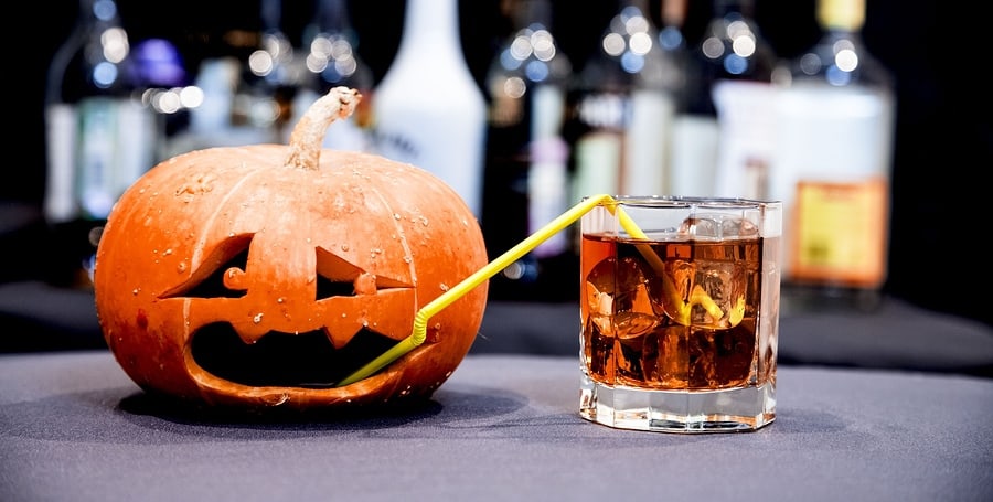 Pumpkin sips on some booze at a Halloween party