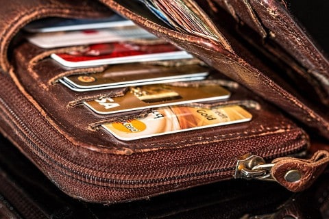a brown wallet full of credit cards