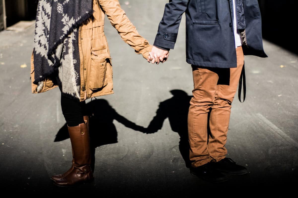 Couple holding hands on a street