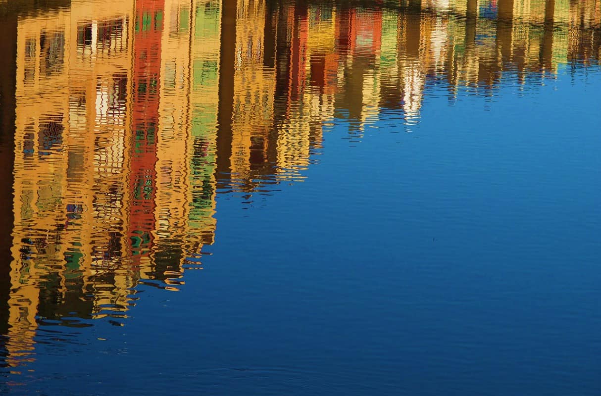 reflection of homes in Spain on water
