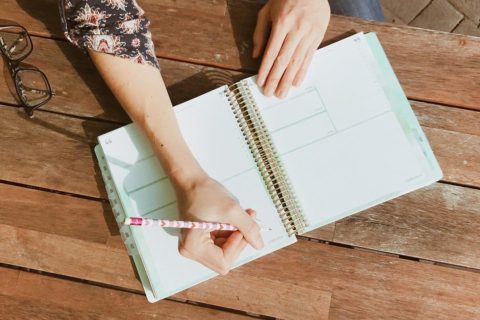 woman writing in her kitlife planner