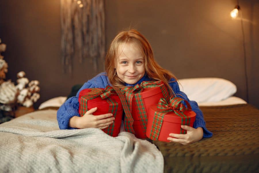 Happy girl grasping Christmas presents