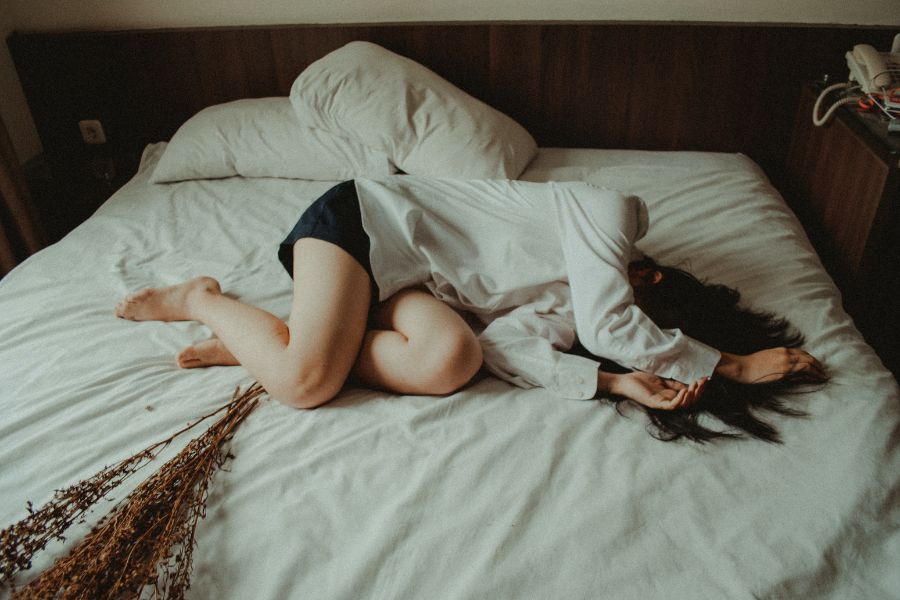 Woman suffering parosmia on bed