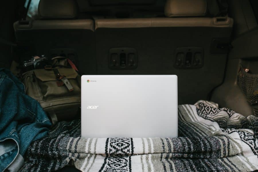 Laptop sitting in back of car to find car insurance