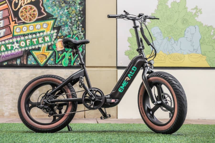 Emerald Ebike in front of a mural
