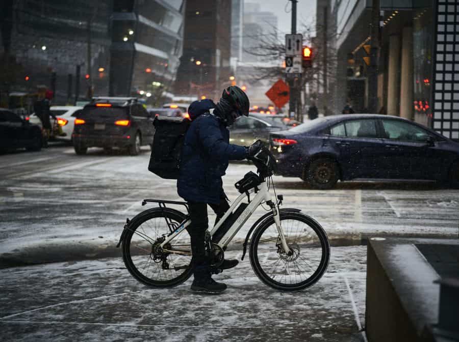 Cyclist in snowy road conditions